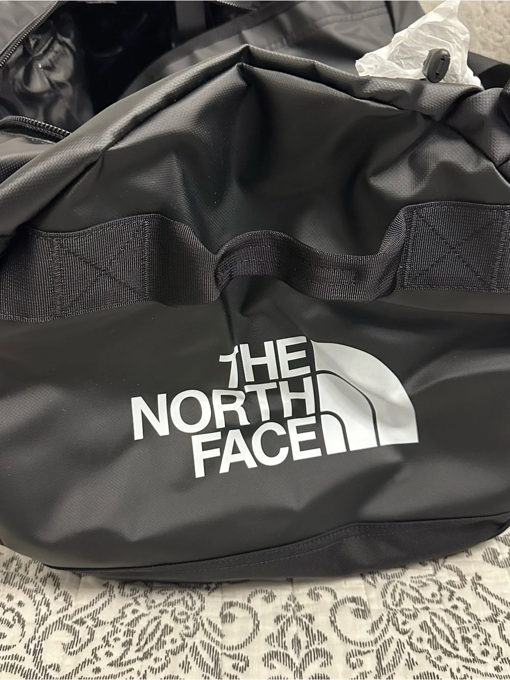 The North Face Base Camp Duffel M in Black with Red Tag